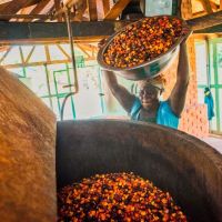 Linda Anim is filling loose palm fruits into one of our steamers.
